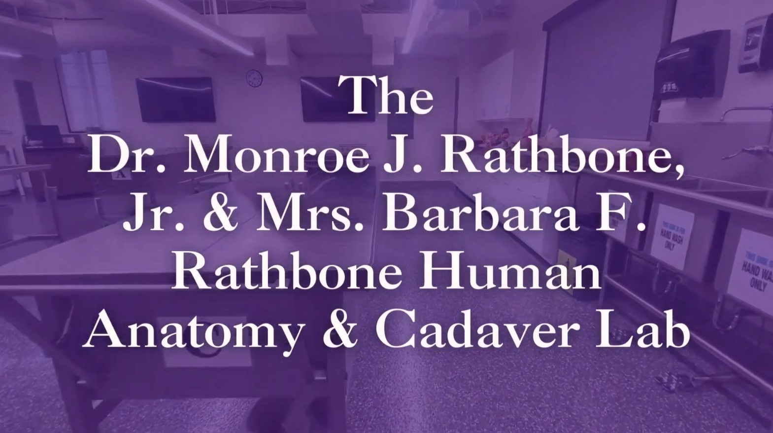 purple overlay over picture of lab with white text: The Dr. Monroe J. Rathbone, Jr. & Mrs. Barbara F. Rathbone Human Anatomy & Cadaver Lab