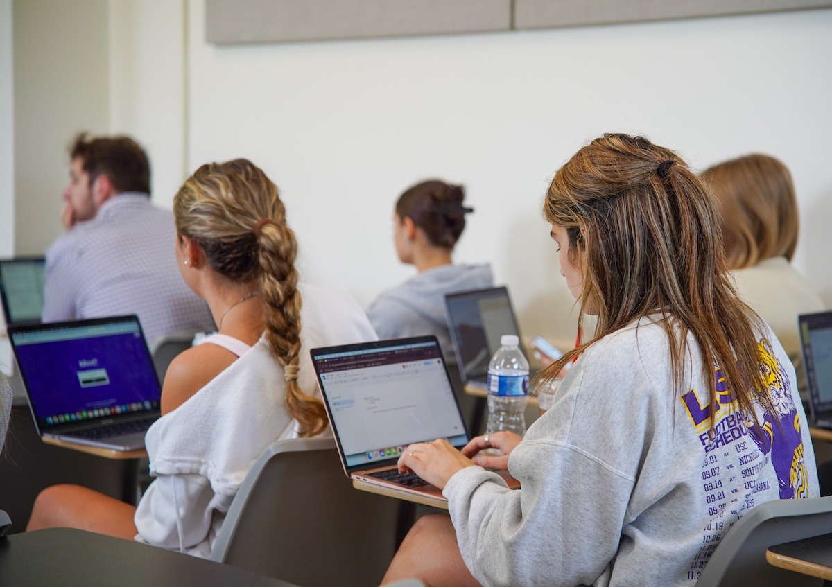 A class of students working on laptops